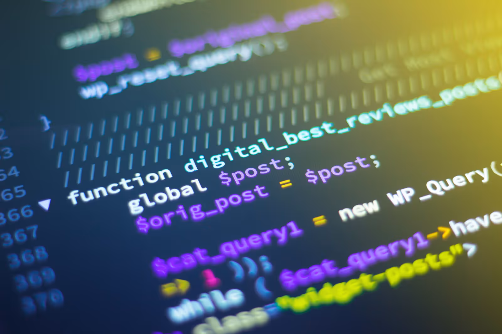 A laptop screen showing lines of source code in a dark editor